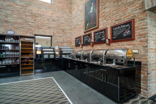 a bar in a wine shop with a brick wall at Hotel Castello & Thermal Spa Siklós in Siklós