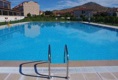 a large swimming pool with blue water at La Granja Villa in La Granja de San Ildefonso