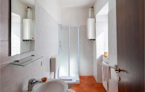 a white bathroom with a sink and a toilet at Valguerriera 7- Rosa Rossa in Apecchio