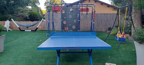 a blue ping pong table in a backyard at וילה בת גליל יסוד המעלה in Yesod Hamaala