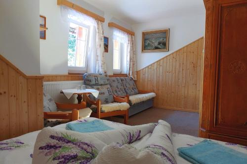 a living room with a couch and a table at Penzion u Veselých in Pec pod Sněžkou