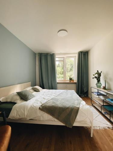 a bedroom with a large bed and a window at Art space at Old Town in Gdańsk