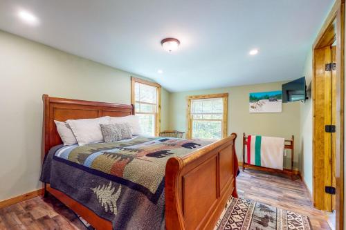 a bedroom with a bed with a wooden bed frame at Coos Canyon Lodge 
