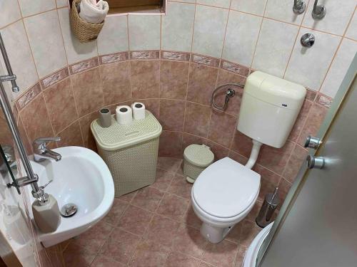 a bathroom with a toilet and a sink at Family friendly home w/ Free Parking & fast WiFi in Skopje