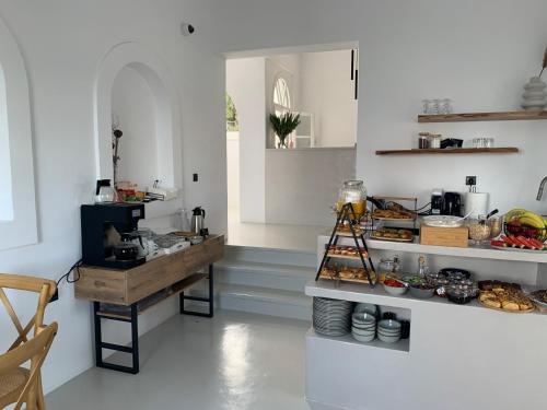 a kitchen with a counter with food on it at Paros Five Senses in Parikia