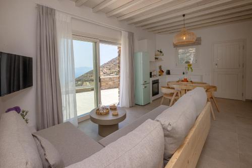 a living room with a large couch and a table at Velouchi Hideout Residence in Tinos