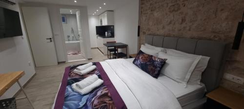a bedroom with a bed with towels on it at Wila properties doo Studio Christopher in Split