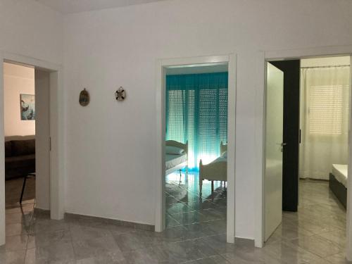 a living room with a table and a window at Azure beach apartment in Orikum