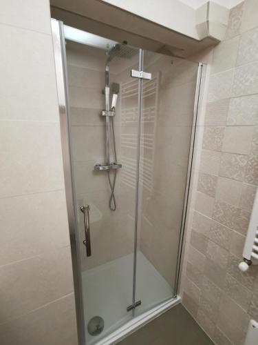 a shower with a glass door in a bathroom at A Casa di Tina in Crispiano