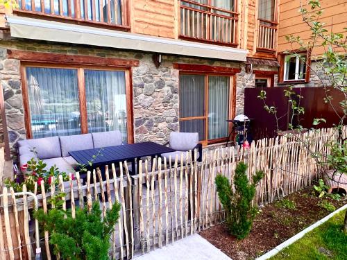 a wooden fence in front of a house at Boutique Apartment Sonnenhang - incl InfinityPOOL in Fliess