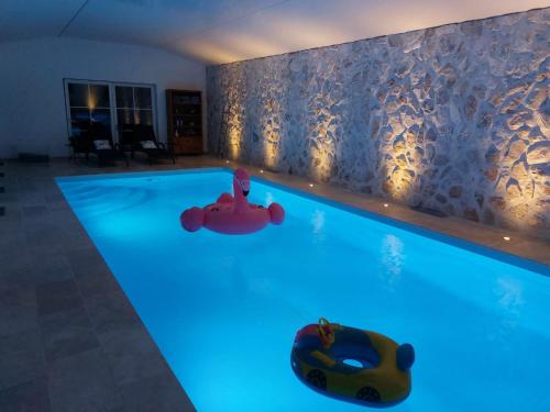 una piscina con luces azules en una casa en Sherlock's Home - Guest House, en Namur