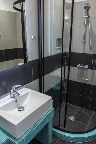 a bathroom with a sink and a shower at Villa Valvis in Perissa