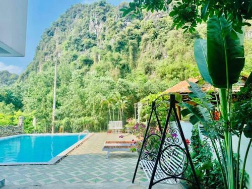 a view of the pool at a resort with a mountain at Phong Nha Moonlight Villas in Phong Nha