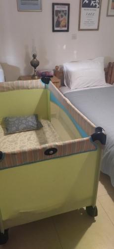 a bedroom with a bed with a green dresser at Grapes and Roses in Igoumenitsa