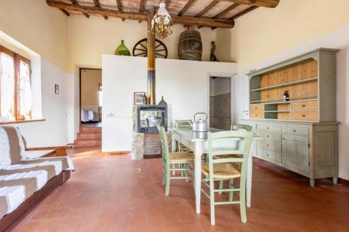 a kitchen with a table and chairs in a room at Castello di Selvole in Vagliagli