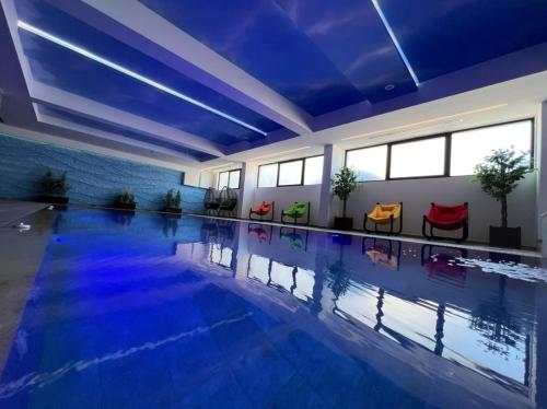 a large swimming pool with blue water in a building at Maghrib in Ulcinj