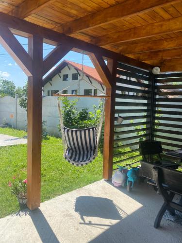 a porch with a hanging hammock in a gazebo at Cabana EvAy in Ocnele Mari
