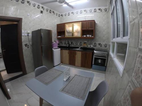 een keuken met een tafel en een koelkast bij chalet IN in Muţī