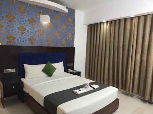 a hotel room with a bed and a window at Shahjadi Resort in Cox's Bazar