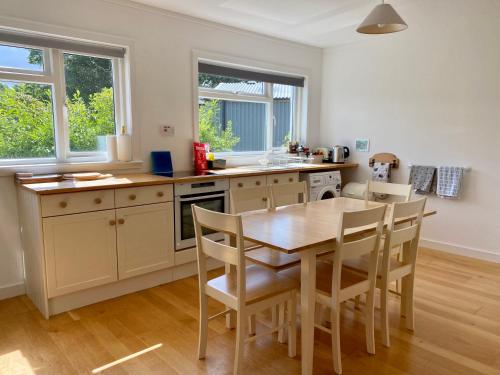 a kitchen with a table and chairs in a room at The Sheiling holiday home with gorgeous views over the isles in Arisaig