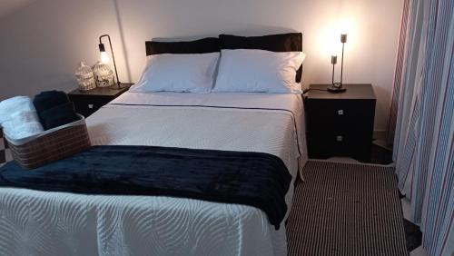a bedroom with a large bed and two night stands at Zawaiaroom in Lagos