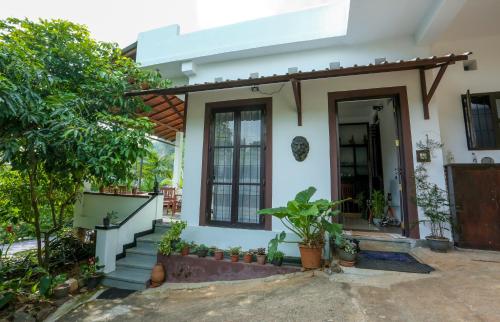 a house with a staircase leading to the front door at Hilltop Retreat Matale in Matale