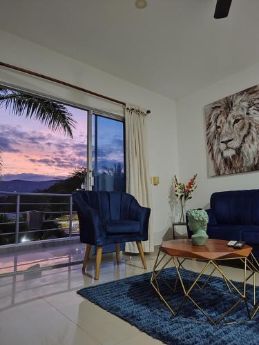 a living room with a lion picture on the wall at Ibiza Reservado 201 in Melgar