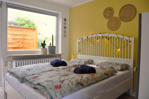 a bedroom with a bed with two pillows on it at Akram Appartement II - Studio - Zentral und Ruhig in Hildesheim