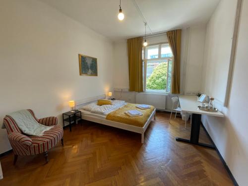 a bedroom with a bed and a desk and a chair at House Elza in Ljubljana