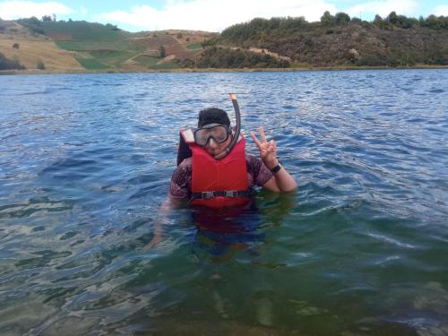 a woman in the water wearing a life vest at Madervill Hospedaje in Aquitania
