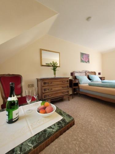 a living room with a table with a bowl of fruit and wine glasses at Ferienwohnung Alte Schmiede in Vogtsburg