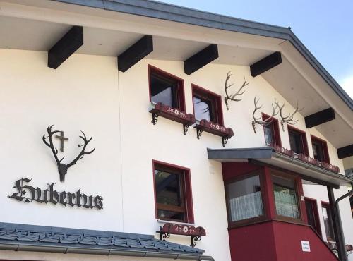 a building with antlers on the side of it at Hubertus Gartenlodge in Mittelberg