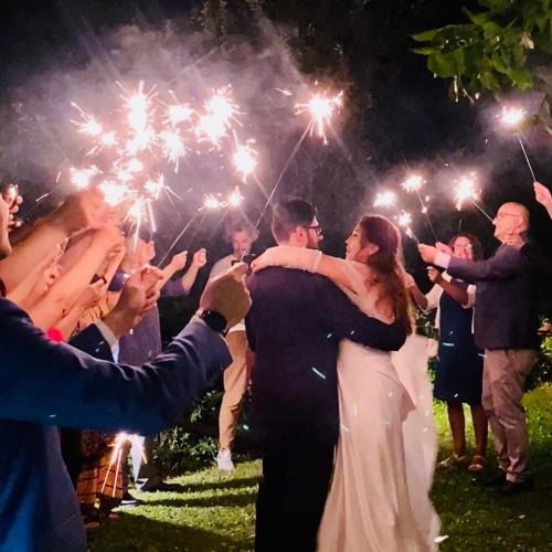 a bride and groom dancing with sparklers at their wedding at Borgo Casale in Albareto