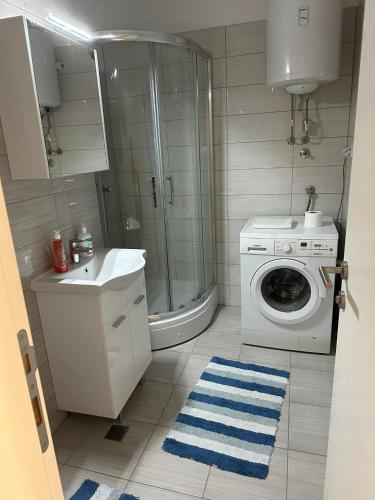 a bathroom with a washing machine and a sink at Luxury apartments - Otoka Sarajevo in Sarajevo