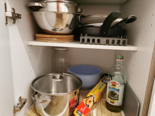a cupboard with pots and pans and other kitchen items at Gelsenkirchen, 2-Zimmer Wohnung , 6 Person in Gelsenkirchen
