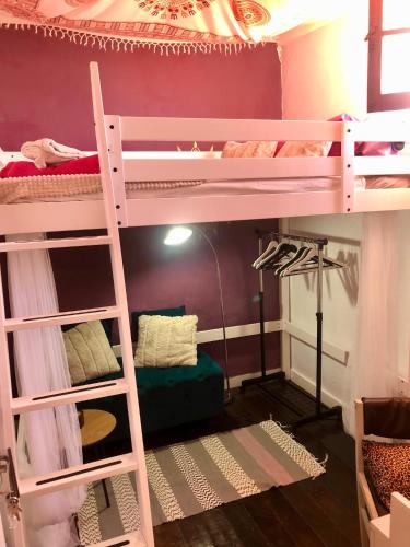 a room with two bunk beds with a ladder at Buddha Bee - 18 to 35 years old only in Lagos