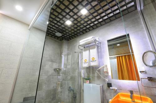 y baño con ducha y lavamanos. en Erdem City Hotel, en Kas