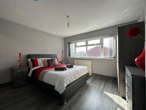 a bedroom with a large bed and a window at Enchanting Escape Castle Vale in Minworth