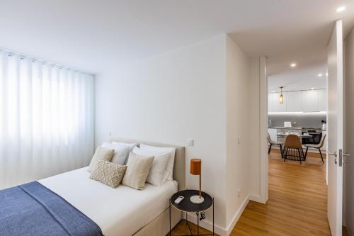 um quarto branco com uma cama e uma sala de jantar em Pestana Apartments - In city center, Modern, New and Cozy no Porto