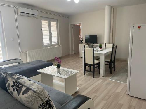 a living room with a couch and a table at Apartmani Vrla in Vladičin Han