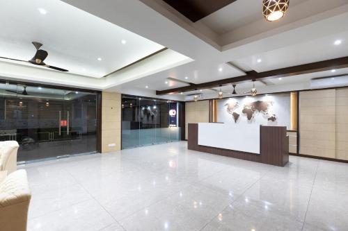 a lobby with a large screen in the middle of it at Sapphero Akshar Inn- Jamnagar in Jamnagar