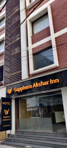 a hotel sign on the front of a building at Sapphero Akshar Inn- Jamnagar in Jamnagar