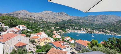 a view of a town with a lake and mountains at RITA - Charming 2-Bedroom Apartment with sea view, Slano in Slano
