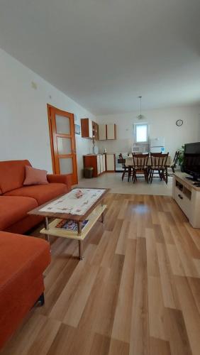 a living room with a couch and a table at Apartman Tija in Orebić