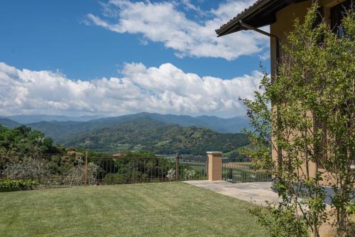 a yard with a view of the mountains at Peaceful Luxury Farmhouse - Stunning Alps Views in Saluzzo