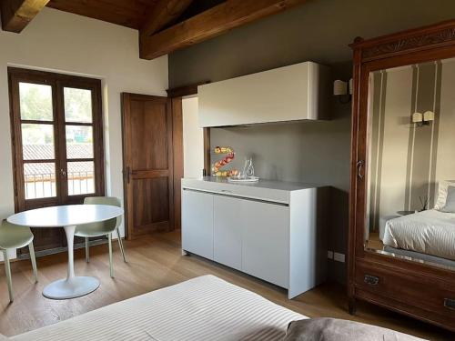 a kitchen with a bed and a table in a room at Peaceful Luxury Farmhouse - Stunning Alps Views in Saluzzo
