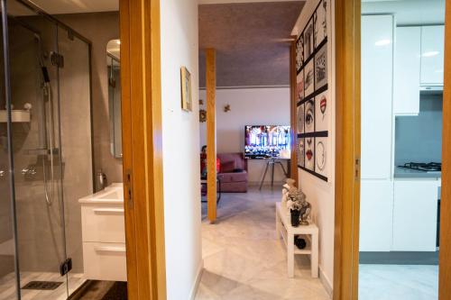 a hallway with a kitchen and a living room at Luxury golden view apartment in les terrasses danfa ain diab in Casablanca