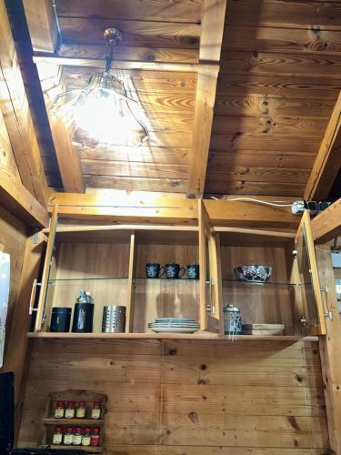 a shelf in a room with wooden walls at Ferienhaus_natikrausz 