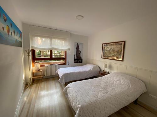 a bedroom with two beds and a window at Apartamento Los Chopos in Santander