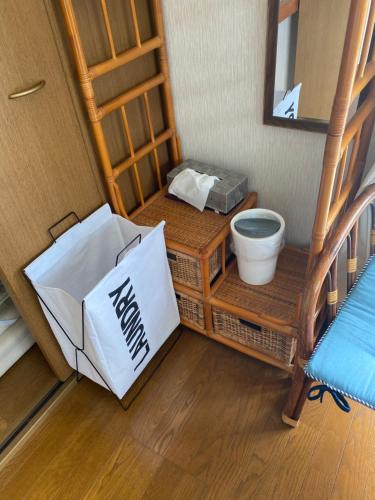 a bathroom with a sink and a toilet in a room at Sun Sea GuestHouse in Yomitan